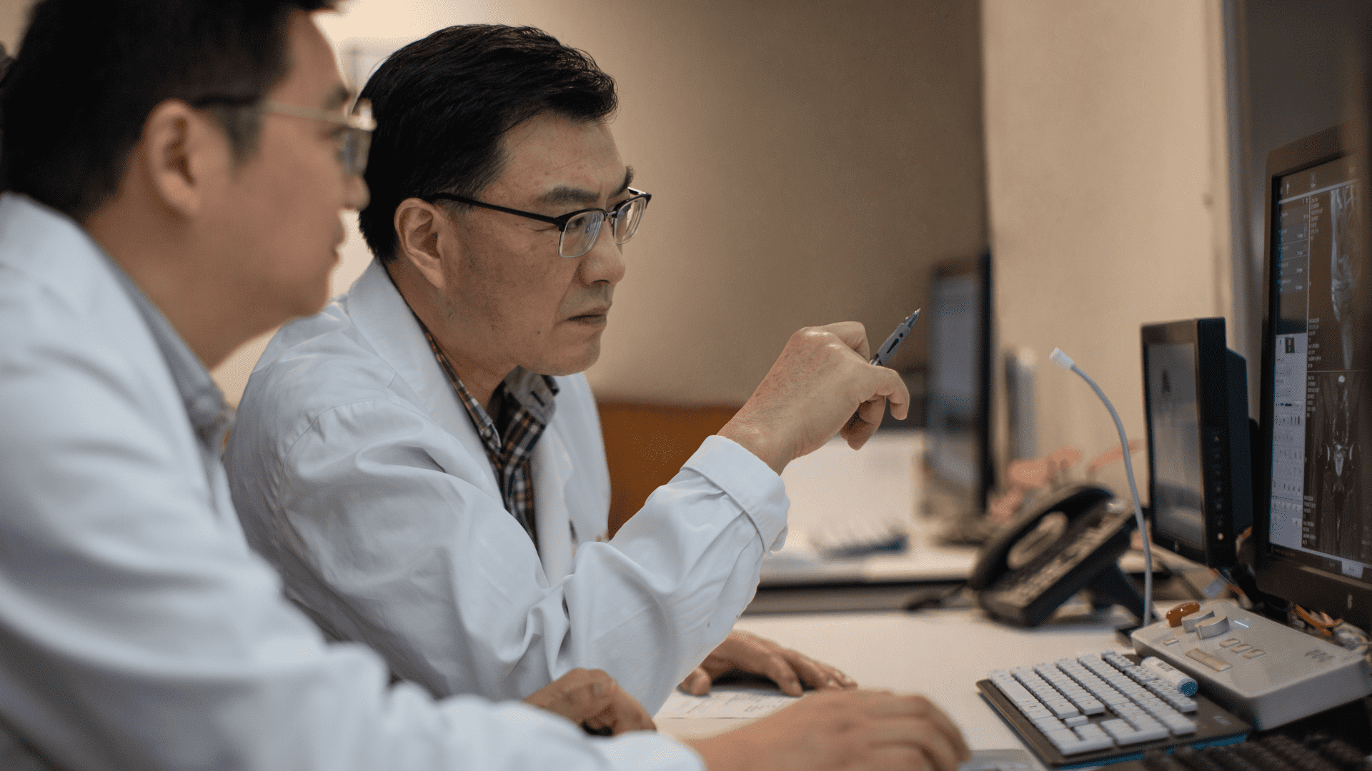 Zhongshan Hospital are collaborating in front of a monitor